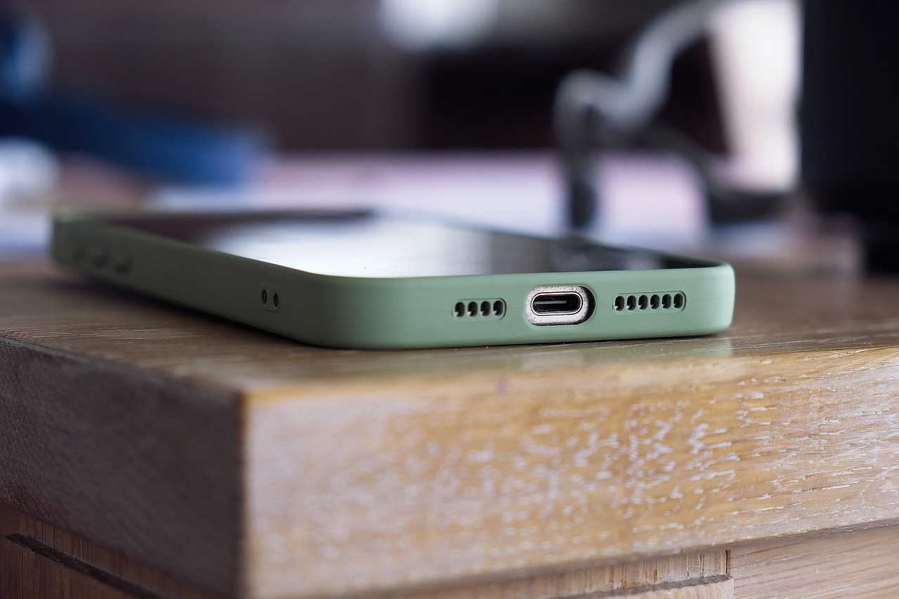 A smartphone resting on a wooden table